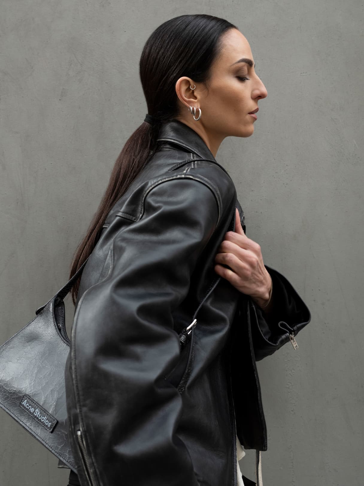 Female model with black Acne Studios bag